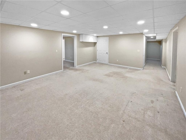 basement featuring light carpet