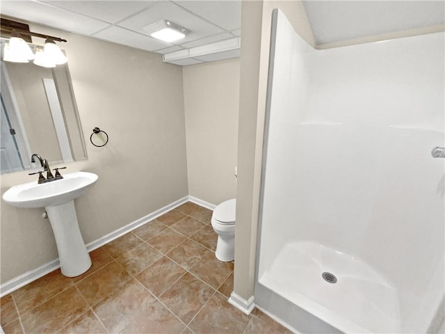 bathroom featuring sink, toilet, and a shower