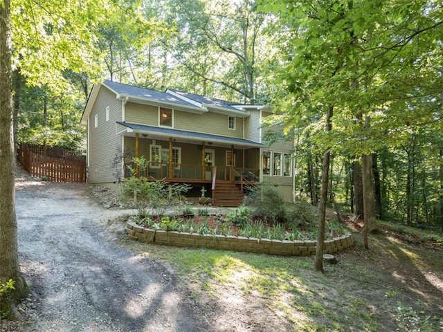 view of front of property with fence and a porch