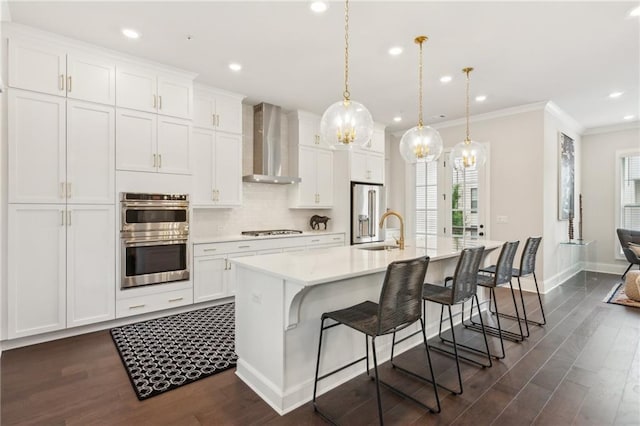 427 Burton Dr, Alpharetta, GA 30009 - kitchen with wall chimney range hood, stainless steel appliances, a sink, a kitchen island with sink, and dark wood-type flooring