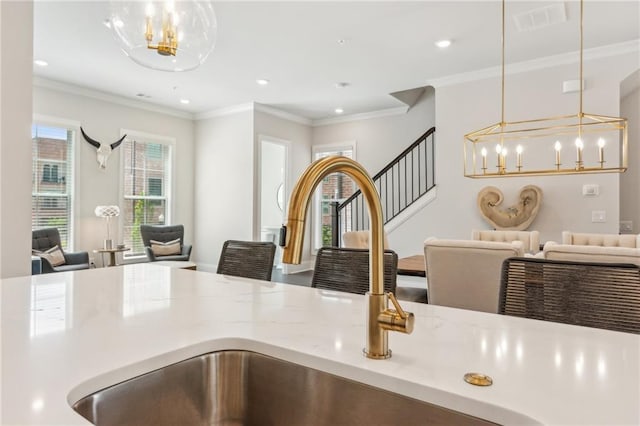 427 Burton Dr, Alpharetta, GA 30009 - kitchen view of a chandelier, a sink, hanging light fixtures, ornamental molding, and recessed lighting