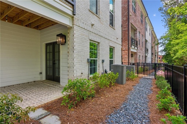 427 Burton Dr, Alpharetta, GA 30009 - view of exterior entry featuring brick siding, french doors, and cooling unit