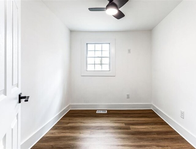 spare room with ceiling fan and dark hardwood / wood-style floors