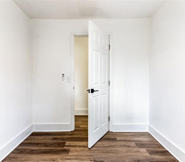 unfurnished room with dark hardwood / wood-style floors