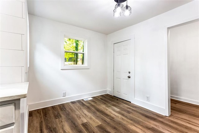 unfurnished bedroom featuring dark hardwood / wood-style floors and a closet