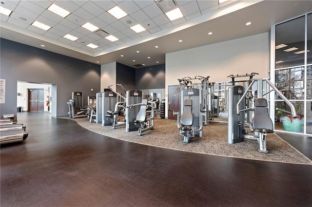 gym with a high ceiling and a drop ceiling