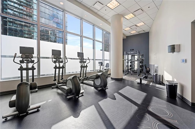 gym featuring a high ceiling and a paneled ceiling