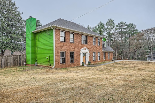 colonial-style house with a front lawn