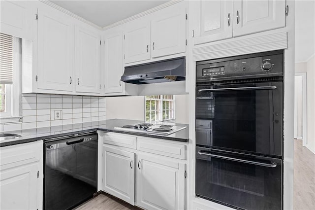 9 Latimer Rd, Cartersville, GA 30121 - kitchen with black appliances, ventilation hood, dark countertops, white cabinets, and decorative backsplash