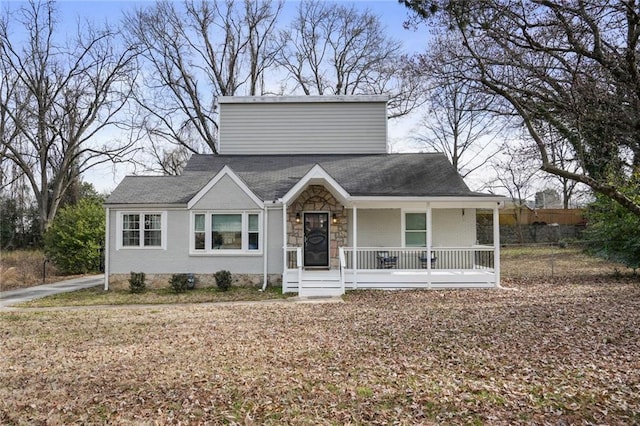 view of front of property with covered porch, stone siding, and brick siding