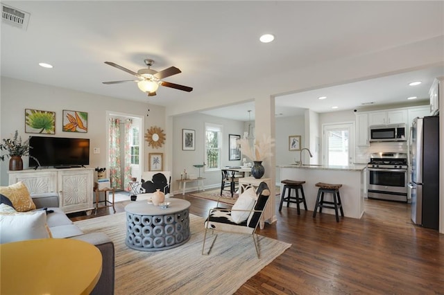 living room featuring visible vents, dark wood finished floors, a ceiling fan, and recessed lighting