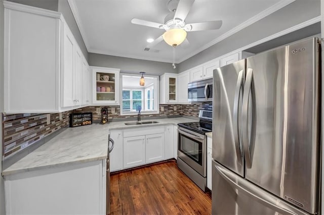 kitchen featuring sink, white cabinets, appliances with stainless steel finishes, light stone counters, and dark hardwood / wood-style flooring