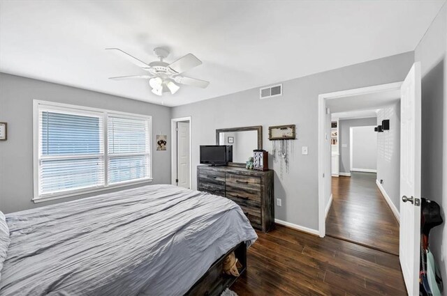 bedroom with dark hardwood / wood-style flooring and ceiling fan