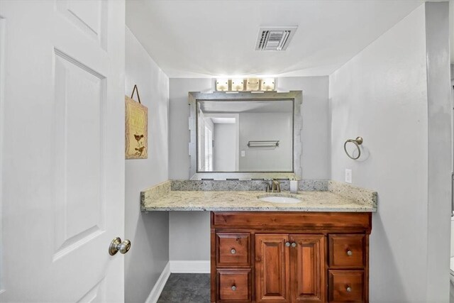 bathroom featuring vanity, toilet, and tile patterned flooring