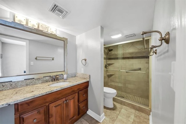 bathroom with vanity, toilet, tile patterned floors, and a shower with door