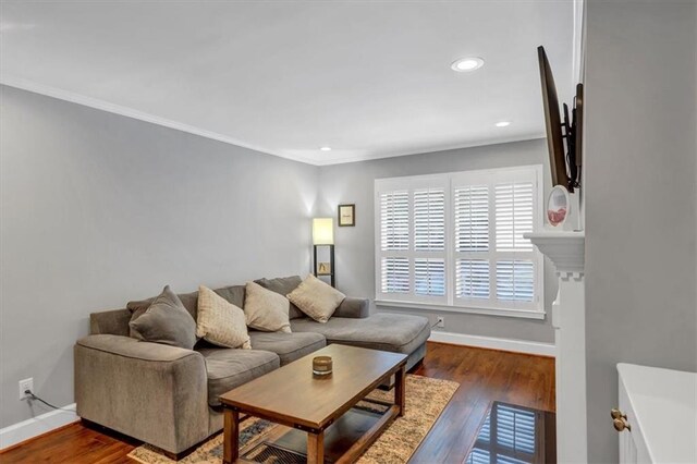 living room with crown molding and dark hardwood / wood-style floors