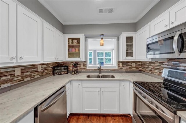 kitchen with sink, appliances with stainless steel finishes, and white cabinetry