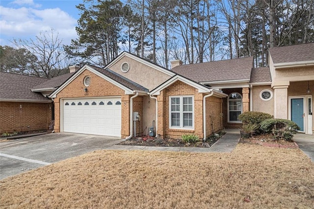 view of front of home with a garage and a front lawn