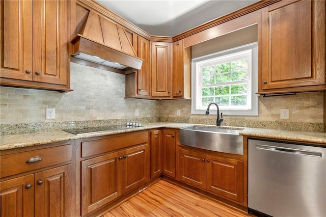 kitchen with dishwasher, a sink, premium range hood, and brown cabinets