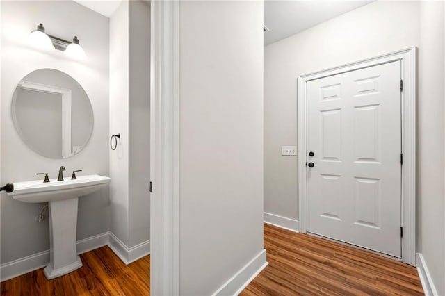 bathroom with baseboards and wood finished floors