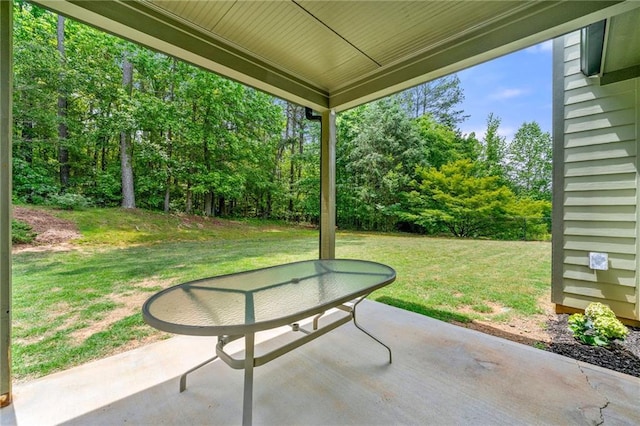 view of patio featuring view of wooded area