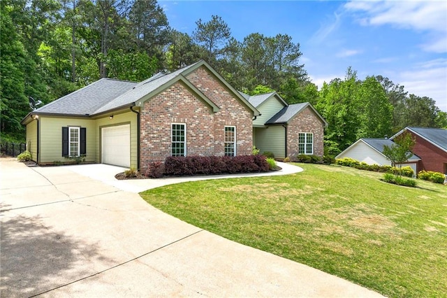 view of front of house with brick siding, driveway, an attached garage, and a front yard