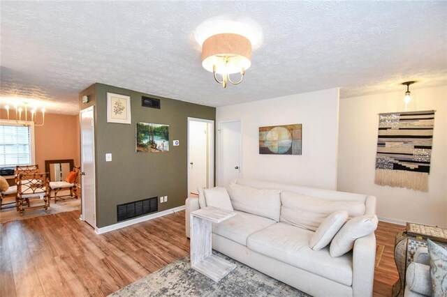 1235 Riverside Dr Unit H3, Gainesville, GA 30501 - living area with visible vents, a notable chandelier, and wood finished floors