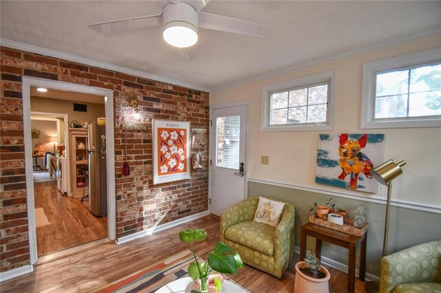 1235 Riverside Dr Unit H3, Gainesville, GA 30501 - living area featuring brick wall, ornamental molding, wood finished floors, and a ceiling fan