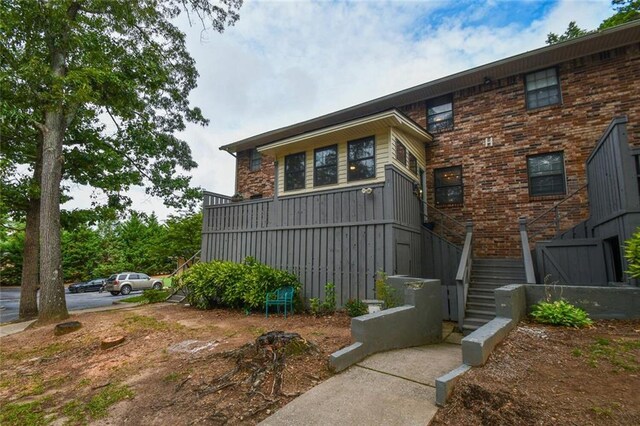 1235 Riverside Dr Unit H3, Gainesville, GA 30501 - view of property exterior with brick siding and stairway