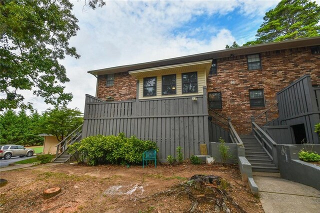 1235 Riverside Dr Unit H3, Gainesville, GA 30501 - view of front facade with brick siding and stairway