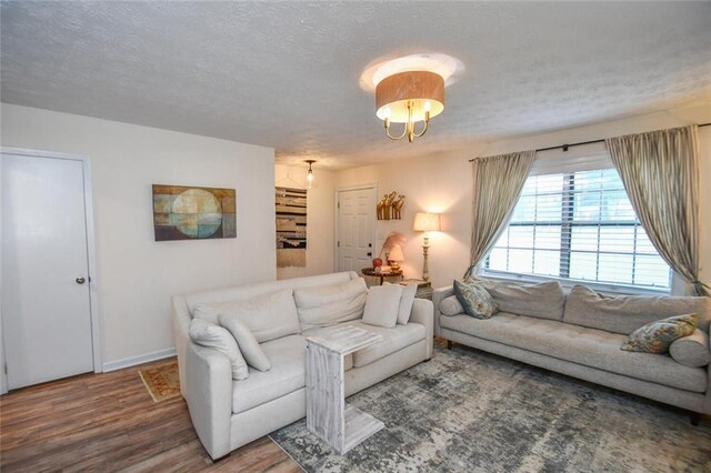 1235 Riverside Dr Unit H3, Gainesville, GA 30501 - living area featuring a textured ceiling, wood finished floors, and baseboards