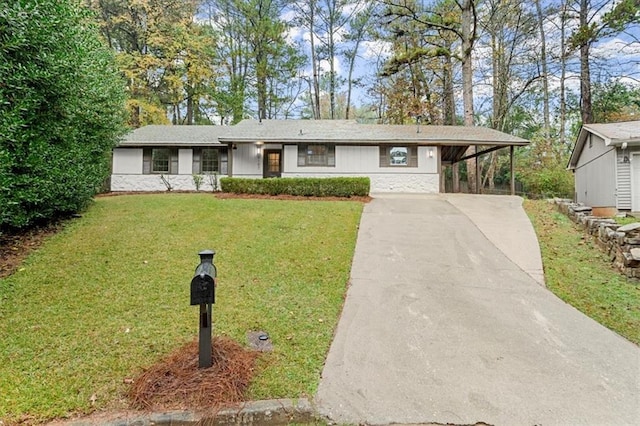 ranch-style home featuring a carport and a front yard