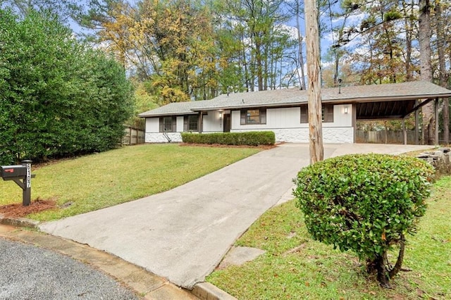 ranch-style home featuring a carport and a front lawn