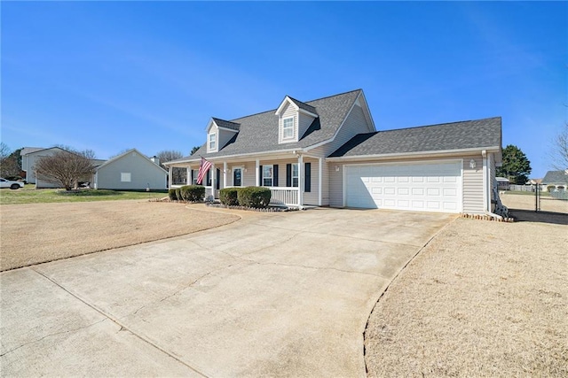 cape cod-style house featuring covered porch, driveway, an attached garage, and fence