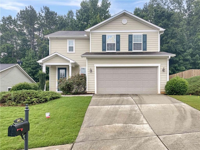 traditional home featuring concrete driveway, an attached garage, fence, and a front yard