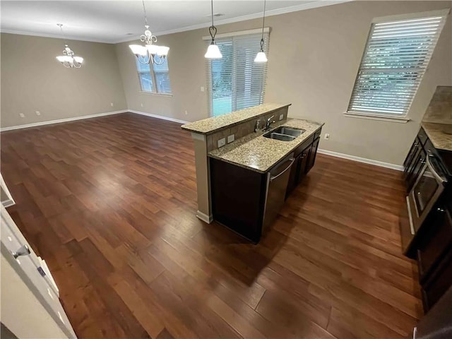 kitchen featuring a sink, crown molding, baseboards, hanging light fixtures, and dark wood-style flooring