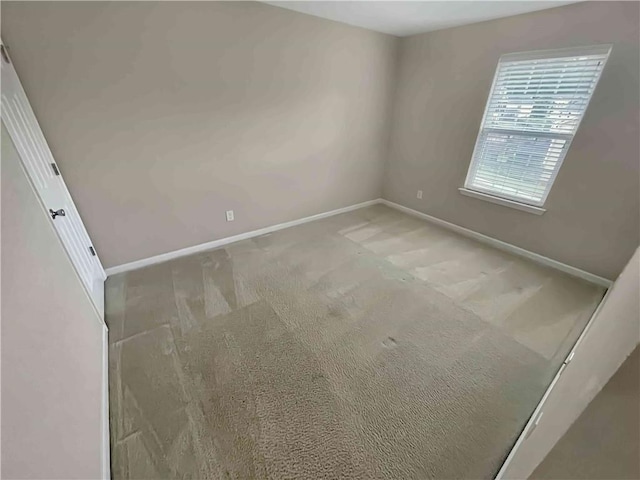 unfurnished bedroom featuring baseboards and carpet flooring