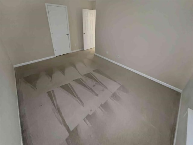 empty room featuring baseboards