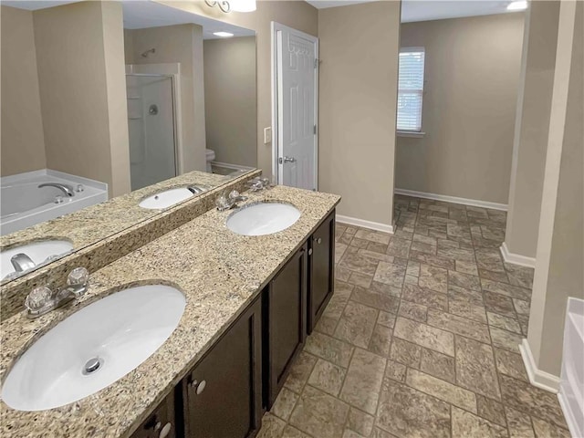 bathroom featuring a shower stall, baseboards, and a sink