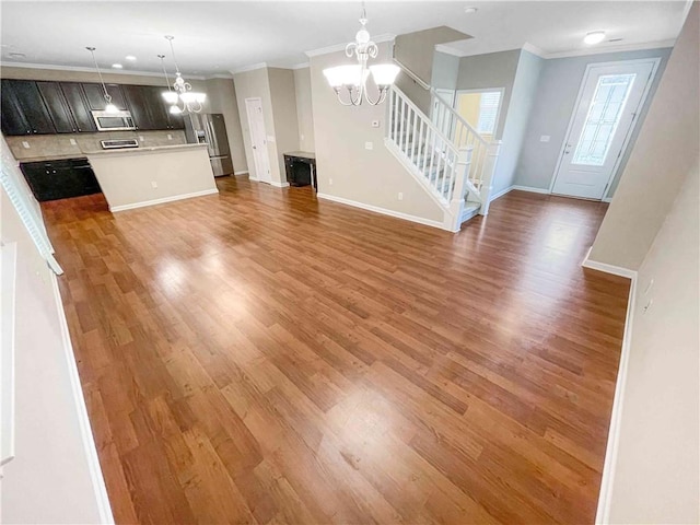 unfurnished living room featuring an inviting chandelier, stairway, crown molding, and light wood finished floors