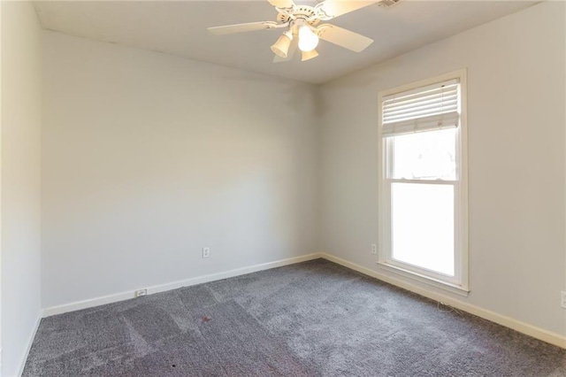 unfurnished room featuring dark colored carpet, ceiling fan, and baseboards