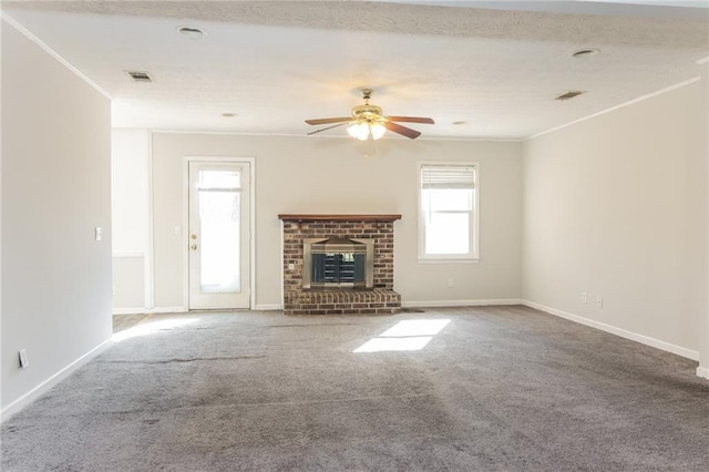 unfurnished living room featuring carpet floors, visible vents, a fireplace, and baseboards