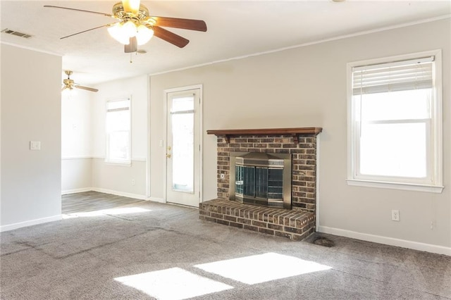 unfurnished living room with a fireplace, visible vents, baseboards, carpet, and crown molding