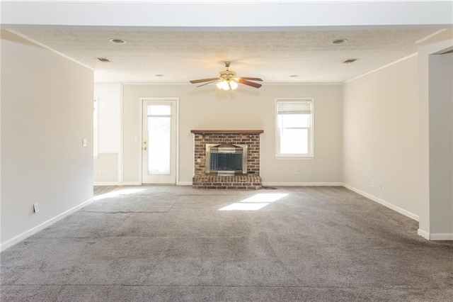 unfurnished living room featuring ornamental molding, a brick fireplace, carpet flooring, and visible vents