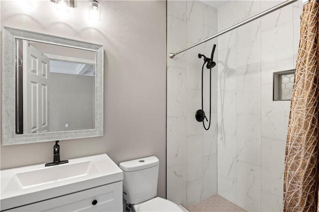 bathroom featuring walk in shower, vanity, and toilet