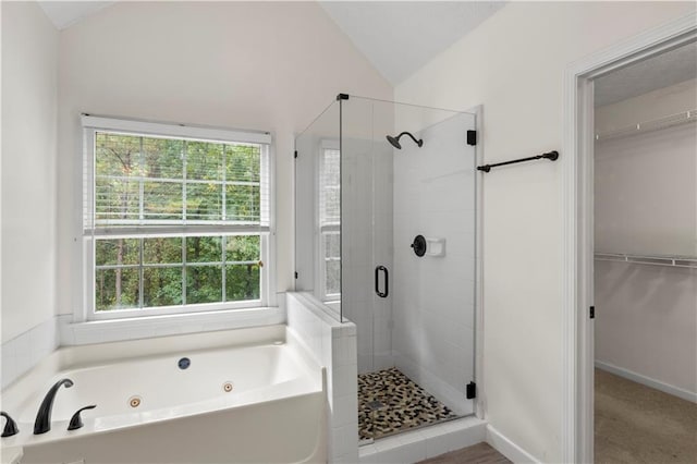 bathroom with shower with separate bathtub, lofted ceiling, and plenty of natural light