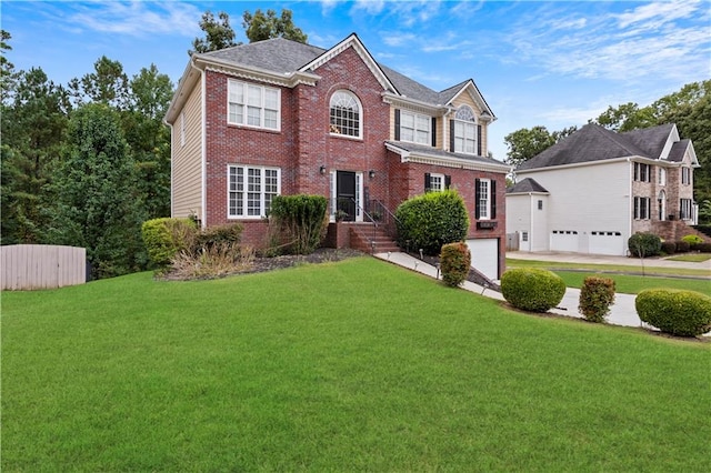 colonial house featuring a front lawn and a garage