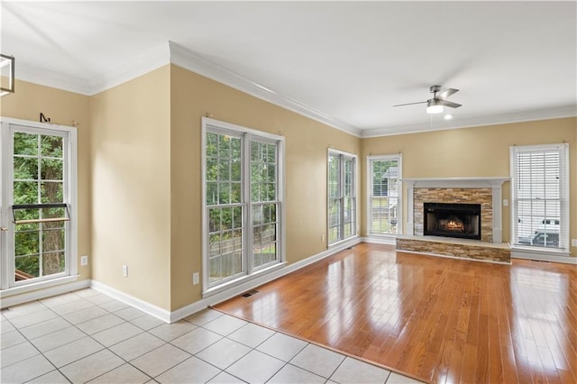 unfurnished living room featuring light hardwood / wood-style floors, ceiling fan, and a wealth of natural light