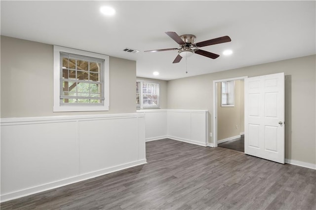 empty room with ceiling fan and dark wood-type flooring