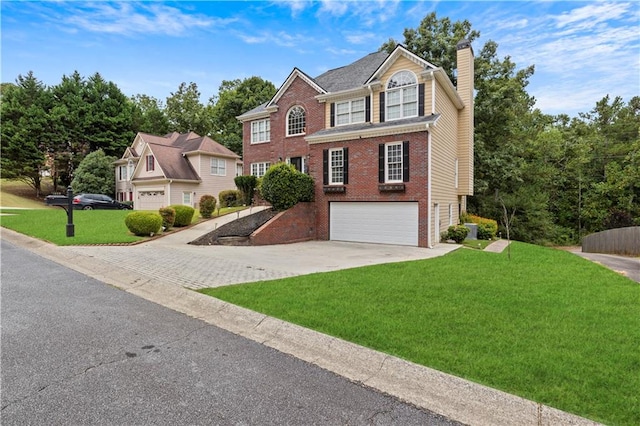 view of front of house with a garage and a front lawn